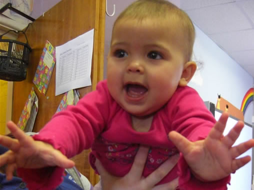 A signing baby at Ashcroft and Ramridge Children's Centre