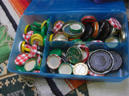 Discovery play with hundreds of jam jar lids!